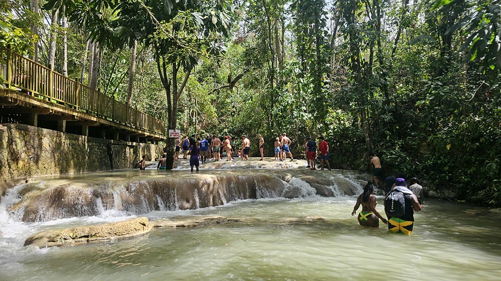 Scenic Jamaican river tour with tropical vegetation and happy tourists enjoying the water